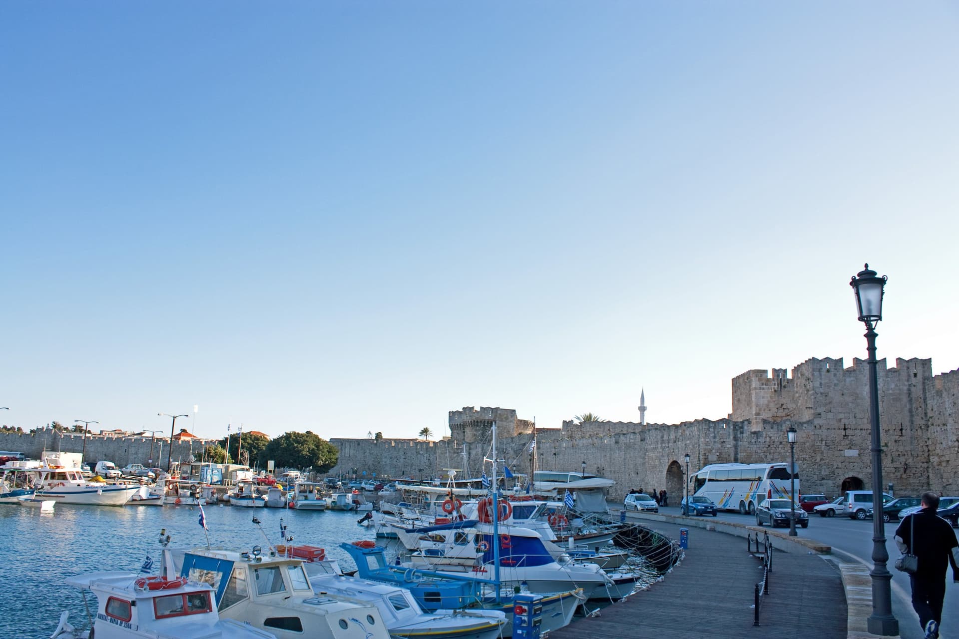 De haven van Rhodos-stad met bootjes voor de middeleeuwse stadsmuren van de oude stad
